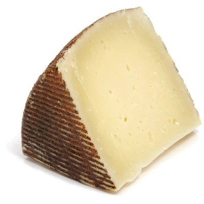 isolated piece of manchego cheese isolated on a white background